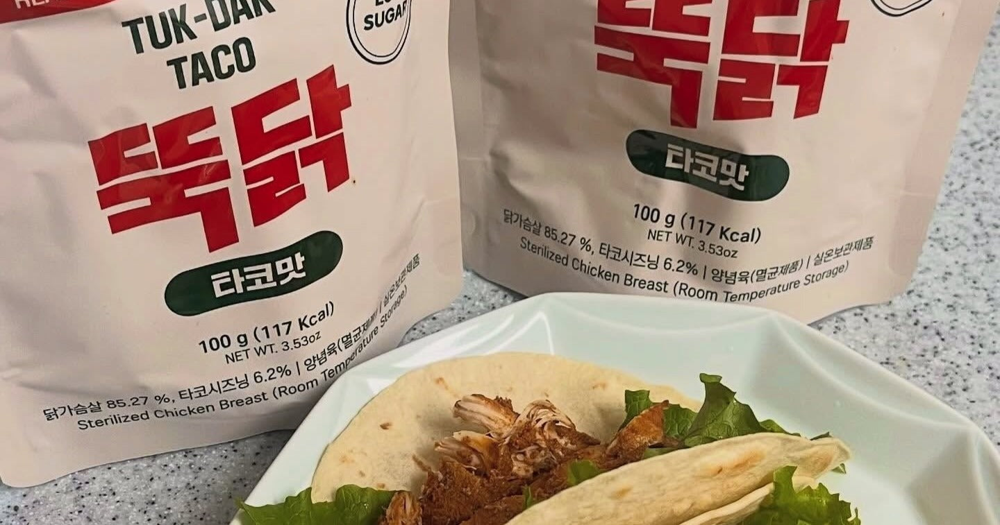 Two Tuk-Dak Taco chicken breast pouches beside a chicken taco