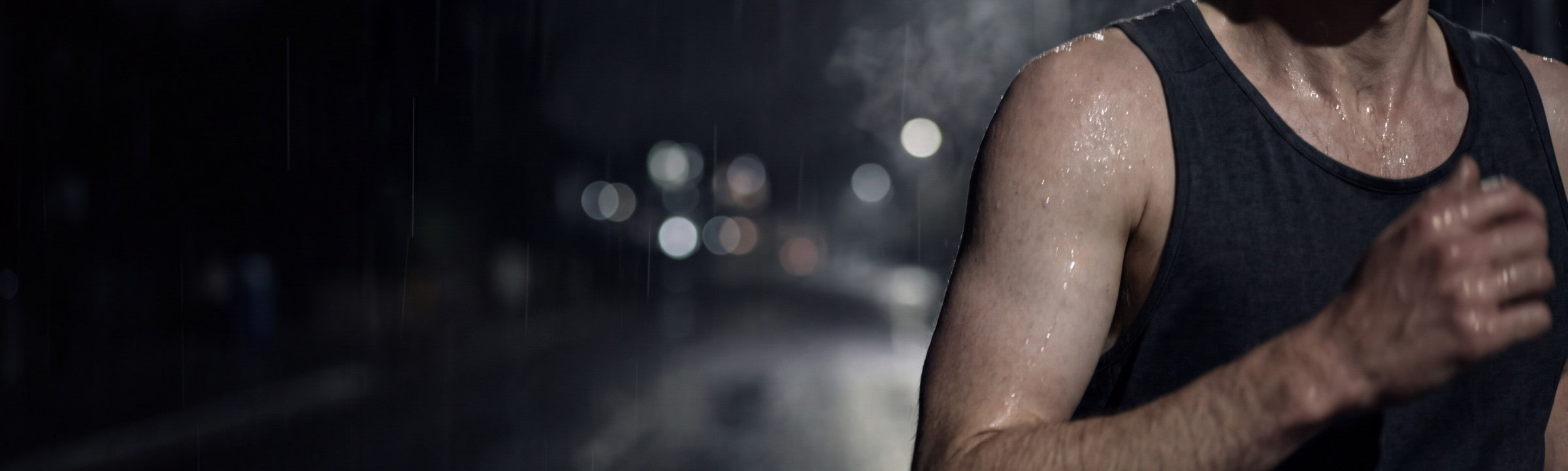 Runner on a wet road at night