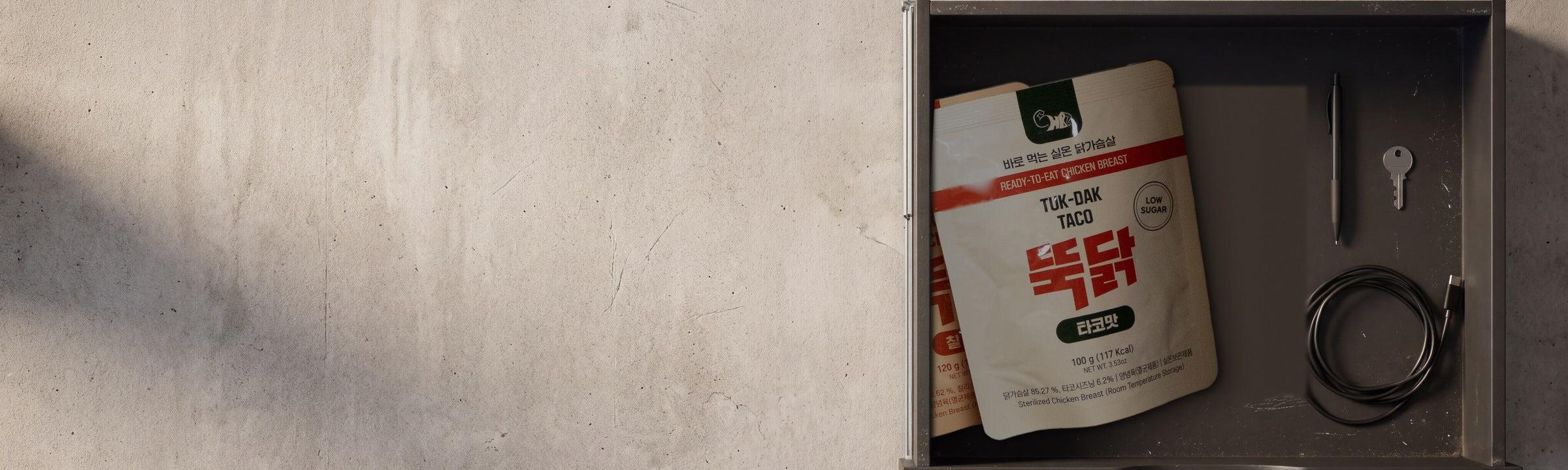 Tuk-Dak shelf-stable chicken breast pouches in a desk drawer